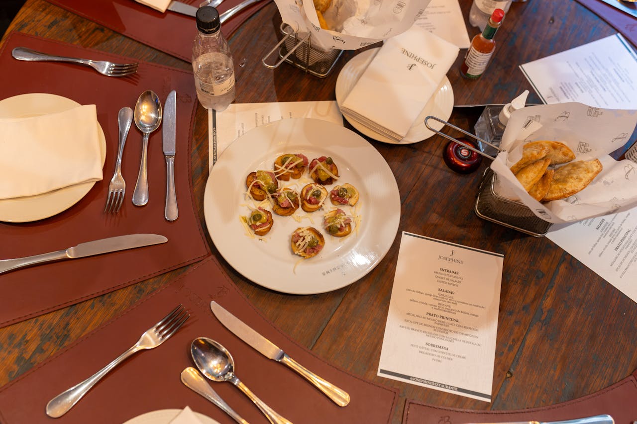 Elegant table setting with gourmet appetizers and cutlery, perfect for a sophisticated meal.