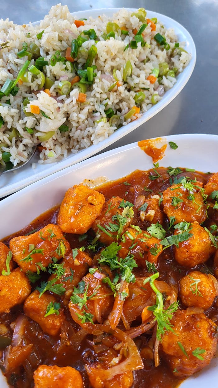 gallery-2 Tantalizing Indian-Chinese fusion dish featuring Manchurian Paneer and flavorful fried rice, perfect for a spicy lunch.