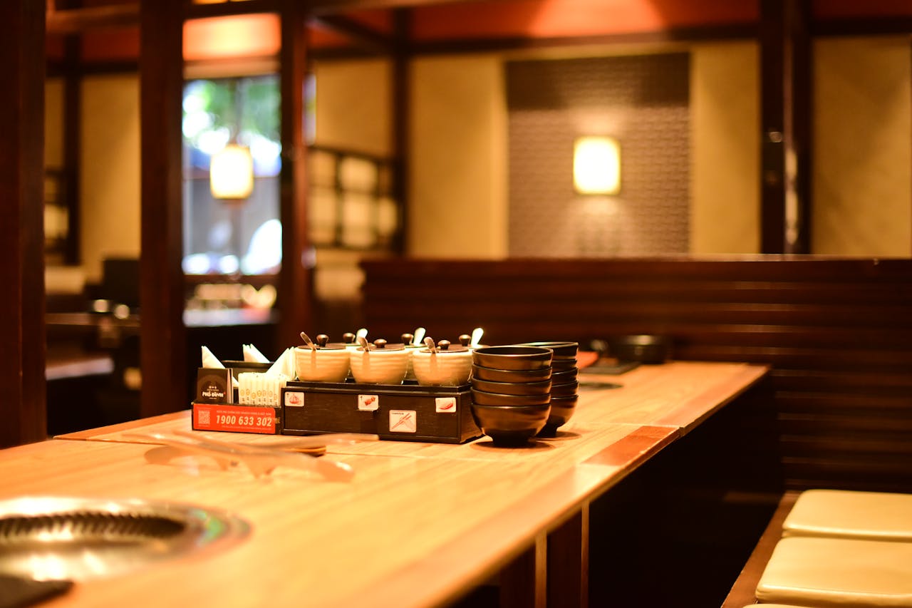 hero-img-01 Warm and inviting restaurant interior with wooden tables and soft lighting, perfect ambience for dining.